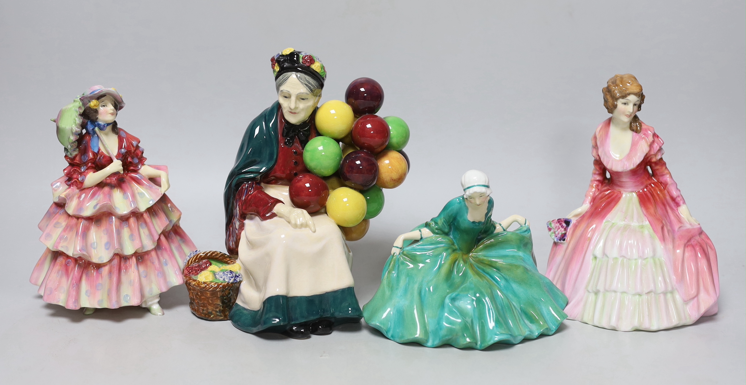 Four Royal Doulton figurines comprising Polly Peachum, Parasol, Charmian and Balloon seller, the largest 19cm high